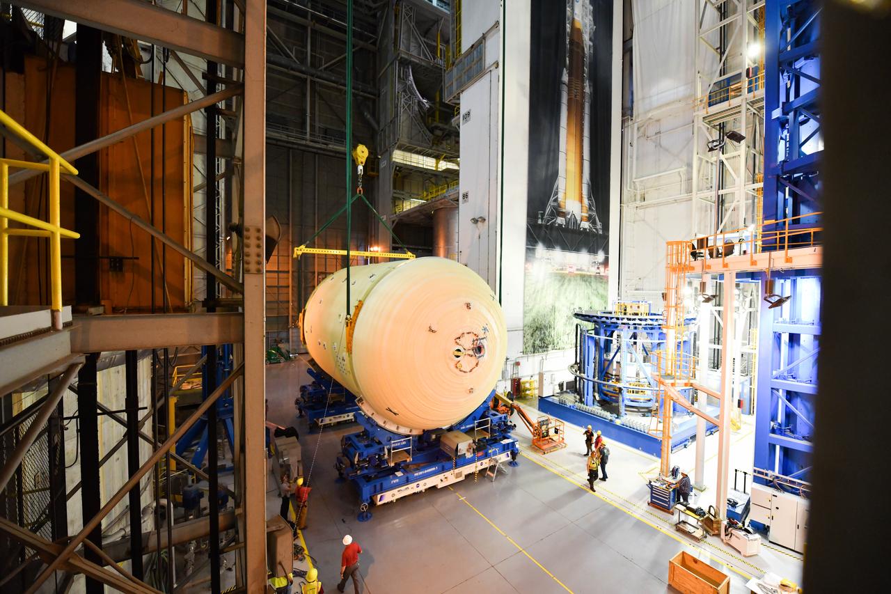 The Space Launch System (SLS) rocket’s liquid oxygen tank structural test article was manufactured and stacked in June 2019 at NASA’s Michoud Assembly Facility in New Orleans. To construct the test article, Boeing technicians at Michoud moved the liquid oxygen tank to the Vertical Assemby Building stacking and integration area. Here, they added simulators to mimic the two structures that connect to the tank, the intertank and the forward skirt.  This structural hardware for the SLS core stage for America’s new deep space rocket is structurally identical to the flight version of the tank. It will be shipped on the Pegasus barge to NASA’s Marshall Space Flight Center in Hunstville, Alabama, where it will undergo a series of tests that simulate the stresses and loads of liftoff and flight. These tests will help ensure designs are adequate for successful SLS missions to the Moon and beyond. The flight liquid oxygen tank along with the liquid hydrogen tank supplies more than 500,000 gallons of propellant to the core stages four RS-25 engines, which produce 2 million pounds of thrust to help send the SLS rocket to space.